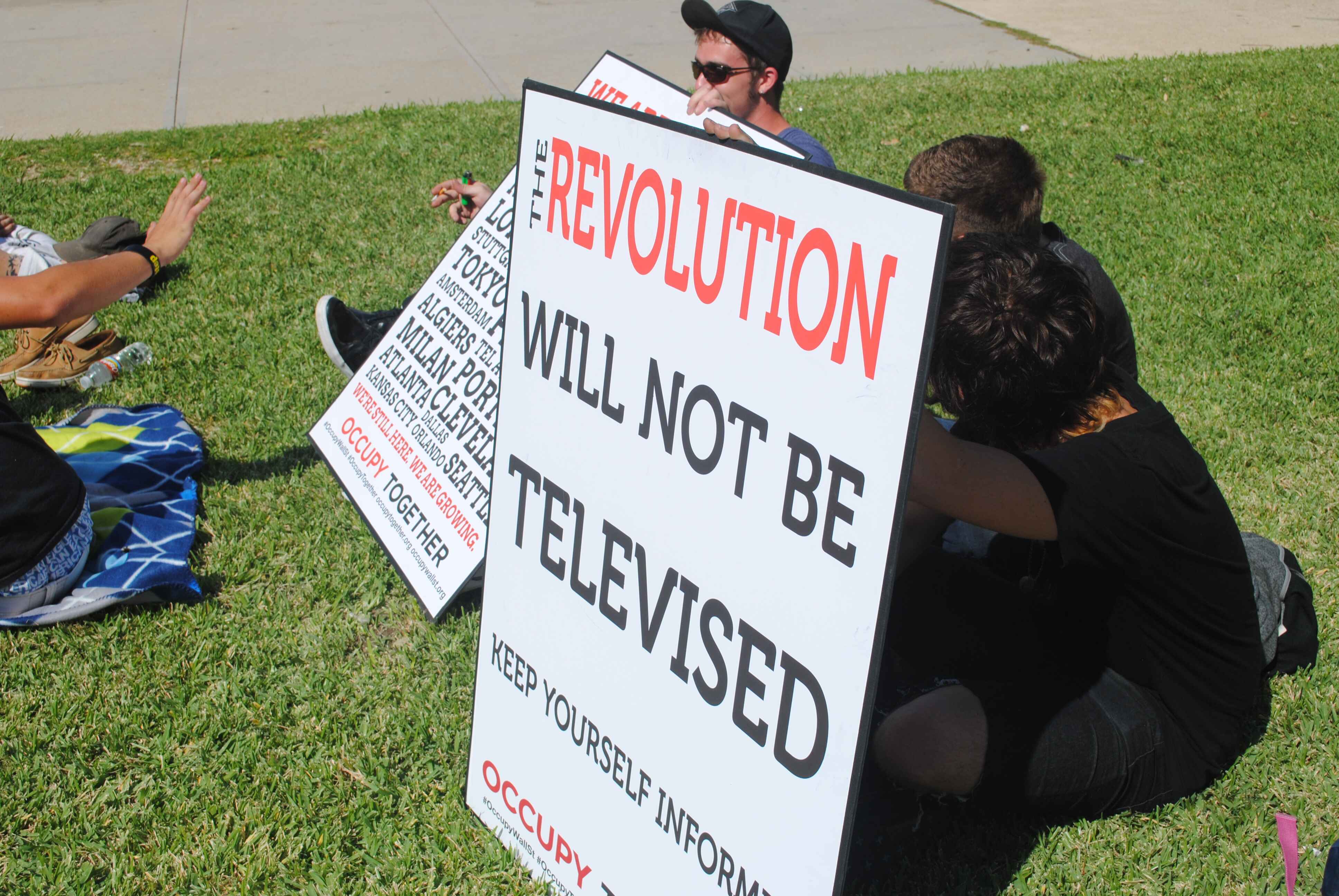 People at a rally holding signs